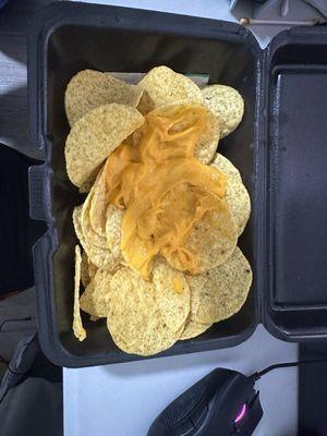 Heres the nachos I received. Barely any cheese and no brisket.