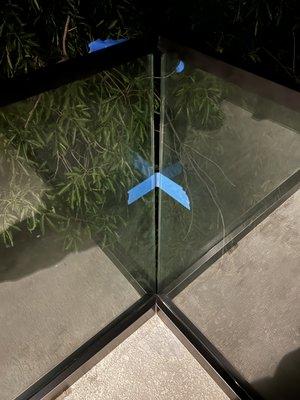 Corner gapping between glass panel. Widens as you go bottom to top.