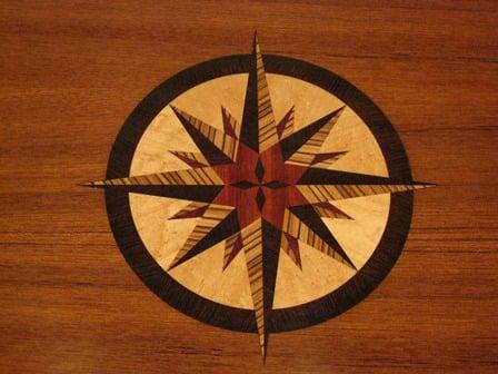 Compass Rose marquetry inlaid into a teak hi-lo table aboard a yacht on Galveston Bay, Texas.