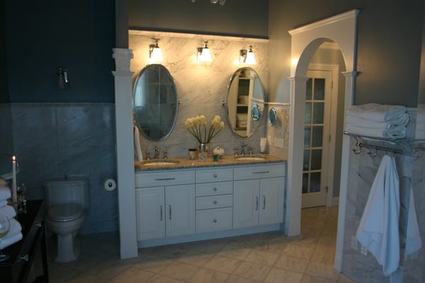 Bathroom remodel with marble floor and custom cabinets