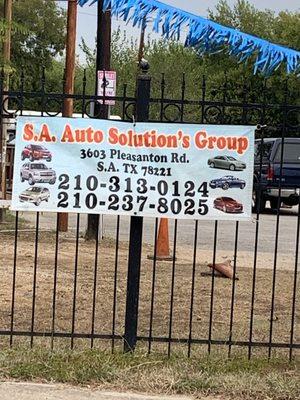 Business sign located on fence