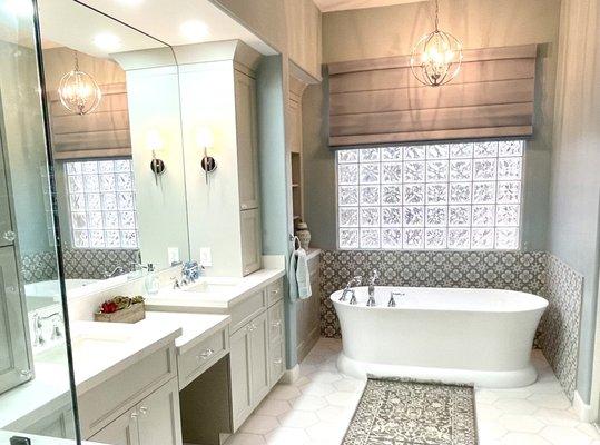 Free standing tub, adjacent shelving and wainscoat  tile