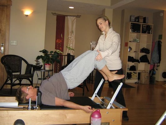 PH trainer teaching proper alignment for back relief exercise.