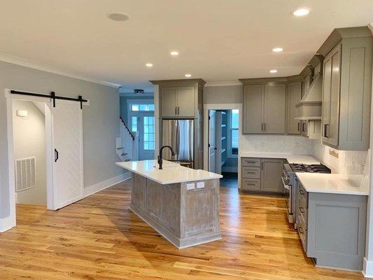 Two tone cabinets with white quartz countertops.