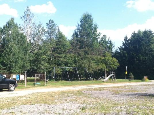 playground for older kids with metal structures, next to swimming hole