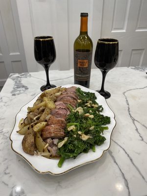 Stuffed Pork Roast with broccoli rabe and roasted potatoes.