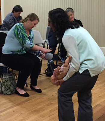 Practicing maneuvers for choking in an infant.