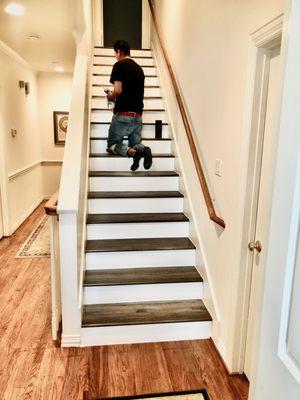 Installed new 12.3mm flooring on stairs with white risers (After)