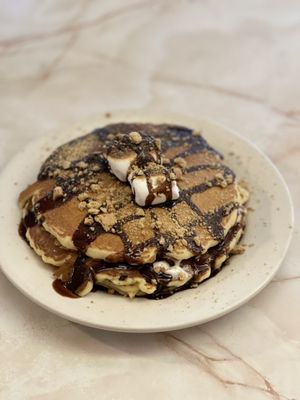 S'mores pancakes with marshmallows, chocolate and graham cracker crumbles.