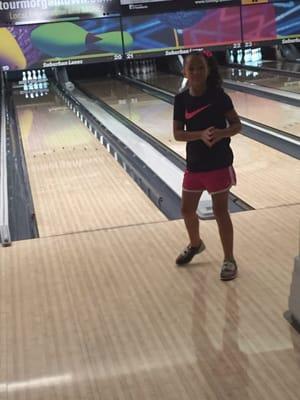 My daughter celebrating after knocking a few pins down. Notice the bumpers