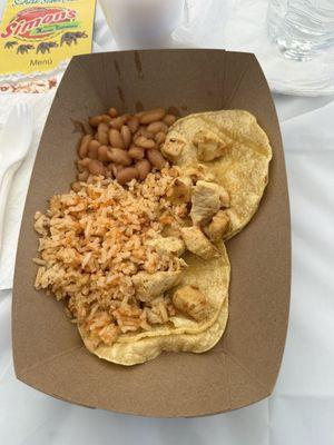 Chicken tacos with rice and beans.