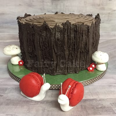 Tree trunk smash cake with meringue mushrooms and macaron snails