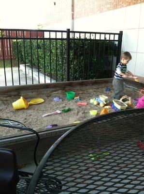 Playing in the sandbox. Keeps the kids entertained.