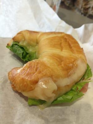 Ham and Swiss croissant with coarse mustard and romaine lettuce