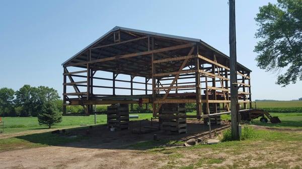 Raising pole building to add height. Home owner wanted to park his big camper inside.