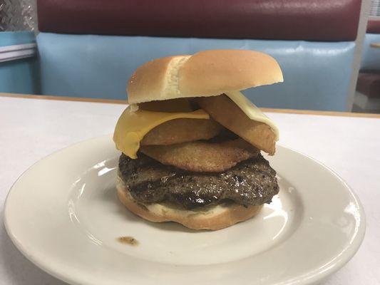 Tootsie Burger, 1/2# Burger topped with 3 onion rings and American & Swiss cheese