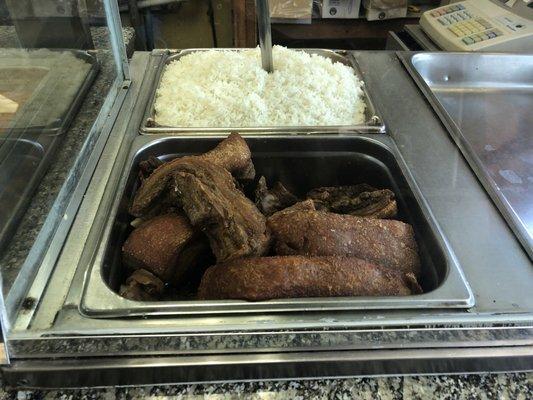 White rice and Dominican style chicharron (fried pork skin) on heating trays. (7/2/2018)