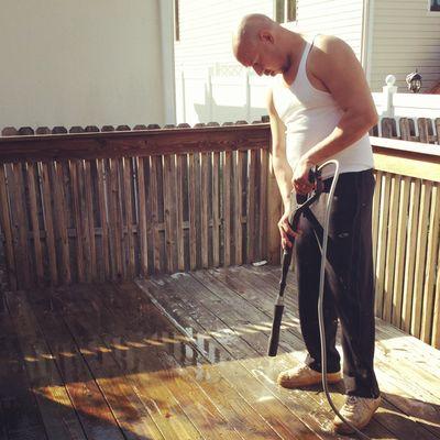 Pressure washing a deck.