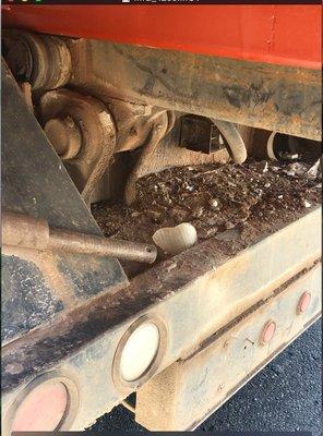 DEBRIS ON THE BUMPER OF JM ROLLOFF - SEE THE GLASS CHARDS AND ROCKS