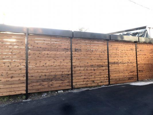 Horizontal fence slats stained and sealed with metal framework