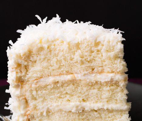 Angie's Coconut Cake. A deliciously delicious coconut cake with vanilla frosting made from scratch.