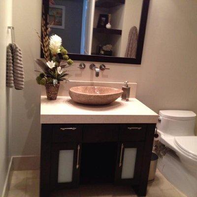 Finished wall mounted faucet with stone vessel sink