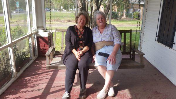 sisters enjoying their new front porch swing