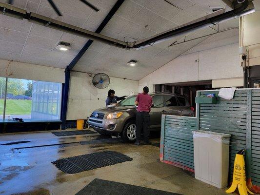 The car is coming out of wash and blow dry.