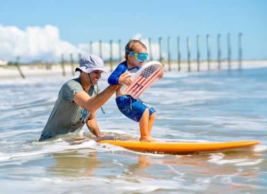 Surfside Chiropractic in Jacksonville's Atlantic Beach.  Dr. Nick Baiata and son surfing together.