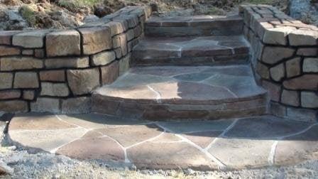 retaining wall and steps of textured and carved concrete.  Most jobs completed within a couple of days.