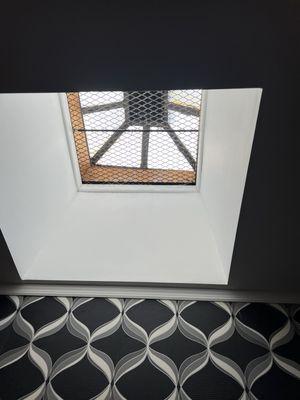 Charming brownstone features- skylight! Note the fabulous wallpaper.