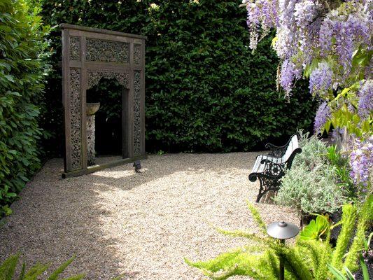 Indonesian art is the focal point for this beautiful garden room