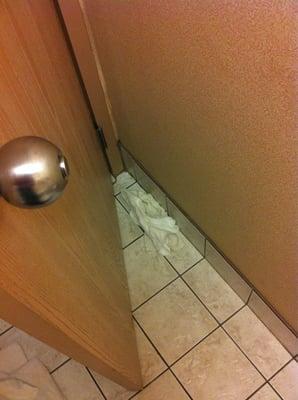 Used towels behind bathroom door