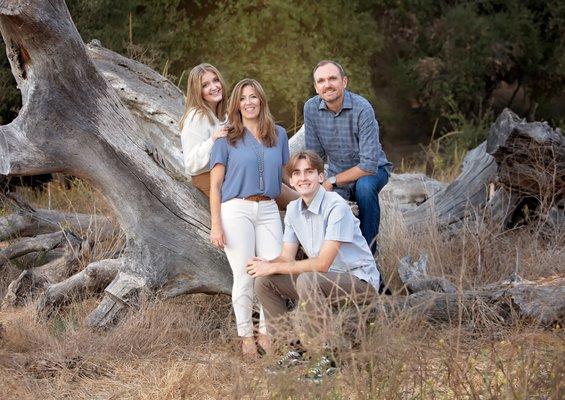 family portrait posed on rustic wood