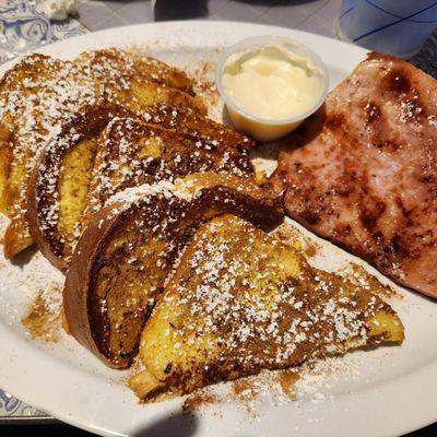 French Toast Plate w/ fried ham slice and cream cheese sauce.