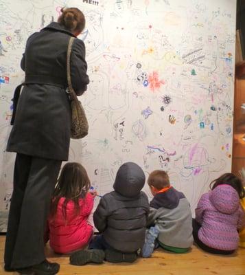 Young artists take advantage of the gallery's drawing wall!