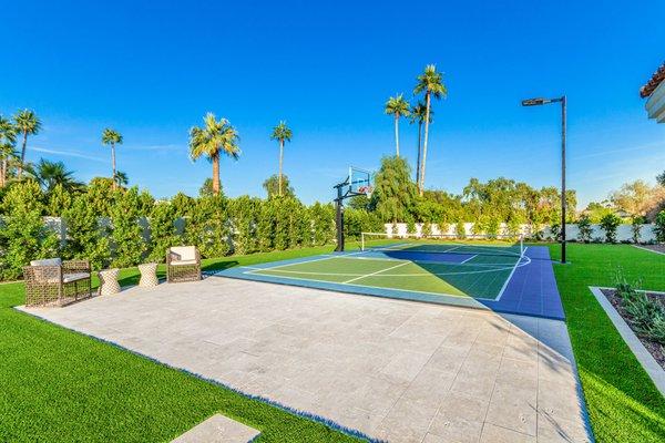 Sport court and seating area, surrounded by artificial turf