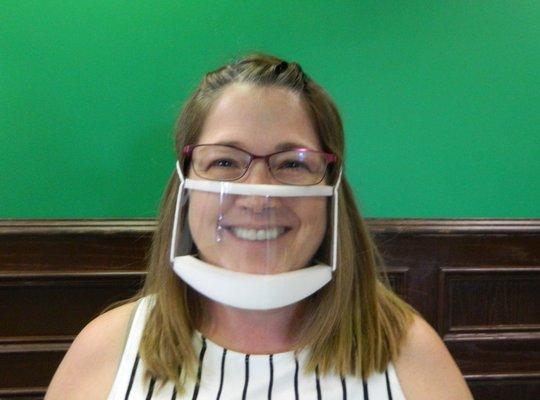 Our staff wears clear communication masks to help ease communication while staying safe. Here's audiologist Angie wearing hers.