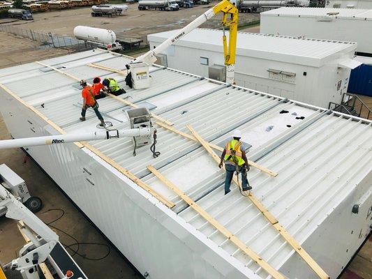 HiWire Bucket Trucks stripping a load for transport