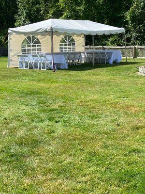 Tent set up from afar w the wrong chairs delivered