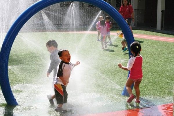 Summer students at play on the spashpad.