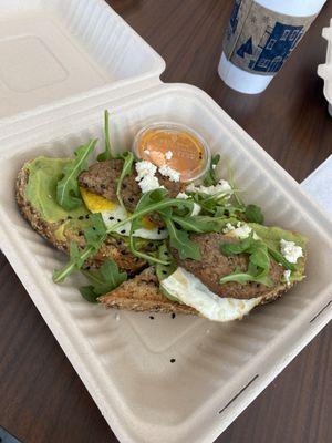 Avocado toast with impossible burger and fried egg sides