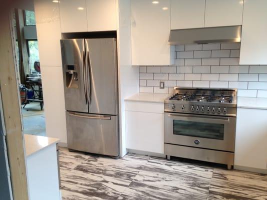 Cabinet installation and floor tile.