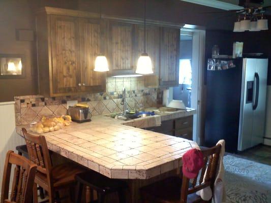 after photo; cabinets custom built, tile countertops installed, slate floors, custom trim package including wainscoting and a...