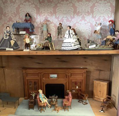 Hand sculpted and dress dolls by miniature artisans and a living room scene.