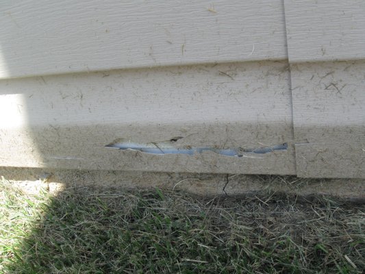 This is the first damage done to home. Metal blade on the edger sheared siding off which Baxter replaced. Same panel replaced 2X!