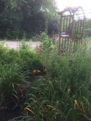 Comfy bench in a pretty garden to wait for the train.