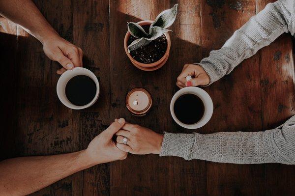 Two people enjoying one another's company over coffee.