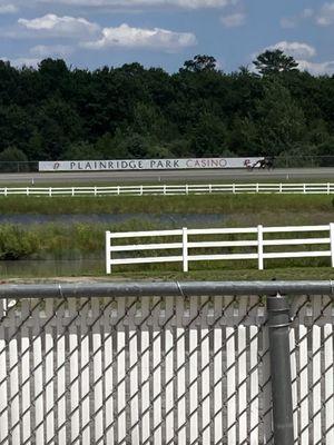 Plainridge, Park, Casino,  and race track w horse  running through