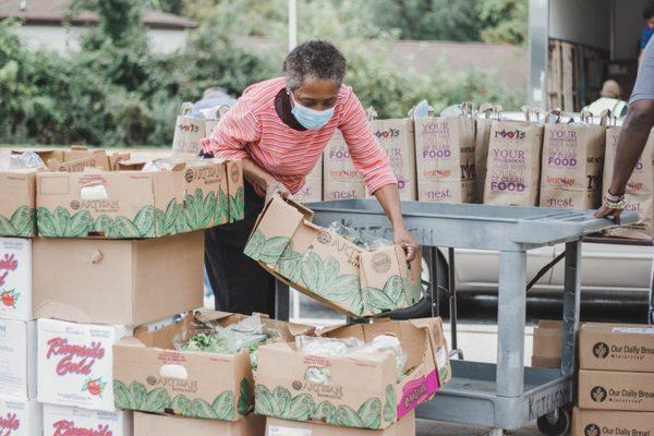 Food Bank distribution day. Organizing fresh veggie boxes to feed 200+ families during Covid season.